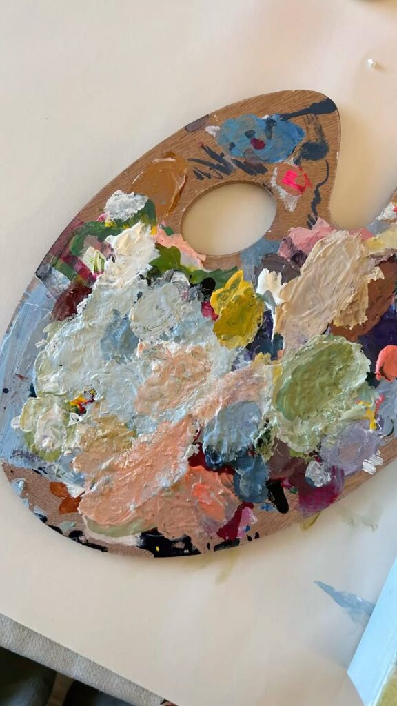 Colorful artist's palette with mixed paint strokes for creative painting projects.