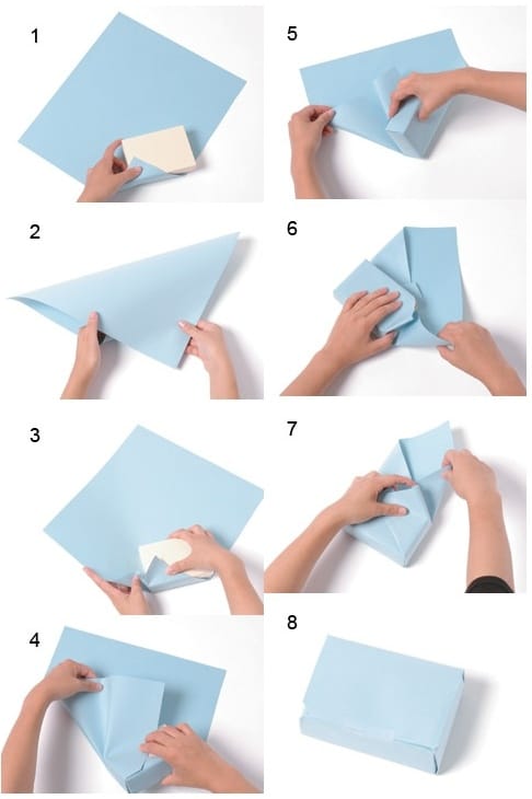 step by step Step-by-step guide to wrapping a rectangular gift with blue paper, showing folding and tucking techniques for a neat finish. | Sky Rye Design Step-by-step guide to wrapping a rectangular gift with blue paper, showing folding and tucking techniques for a neat finish.
