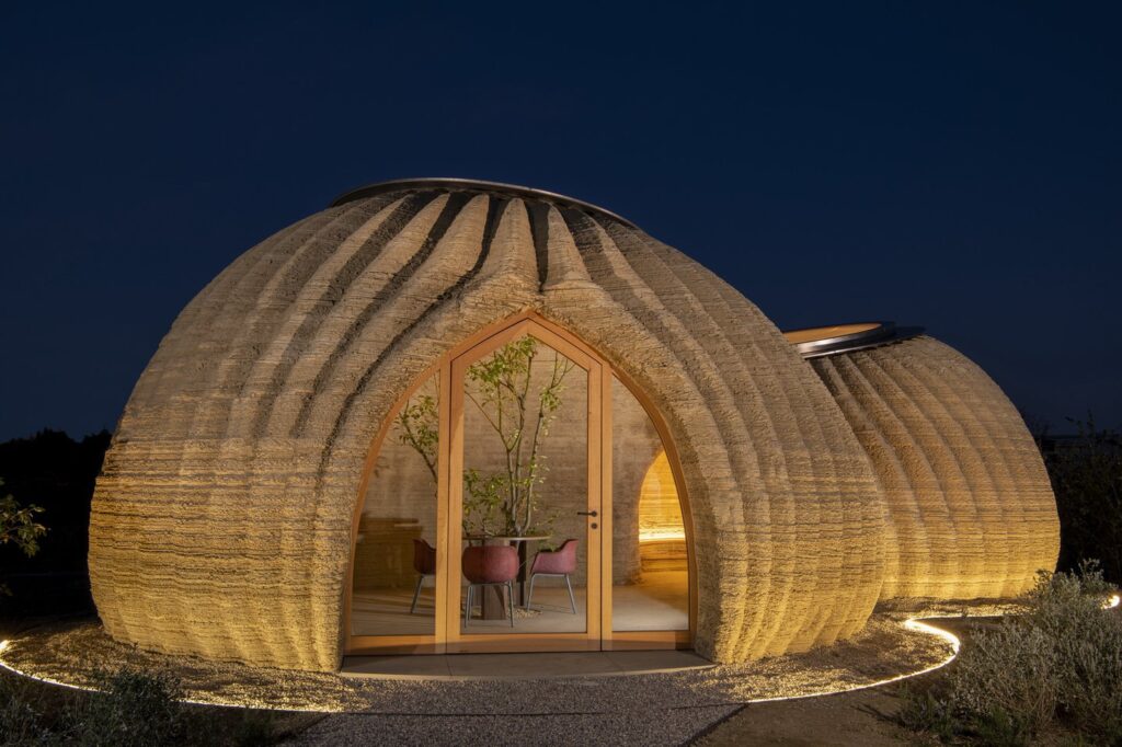 tecla_house_Mario_Cucinella_Architects_WASP_iwidth-1440_A1mfzj3hEYISxlpB 3D-printed eco-friendly house with unique dome design illuminated at night. | Sky Rye Design 3D-printed eco-friendly house with unique dome design illuminated at night.