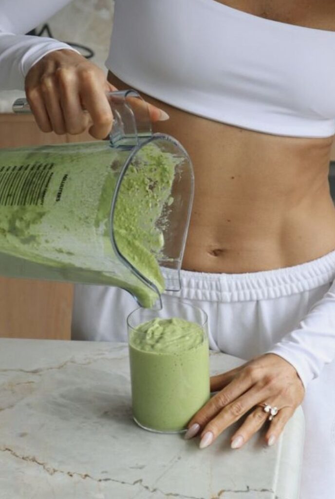 the auclair green gut safe Person pouring green smoothie into glass, showcasing a healthy lifestyle. | Sky Rye Design Person pouring green smoothie into glass, showcasing a healthy lifestyle.