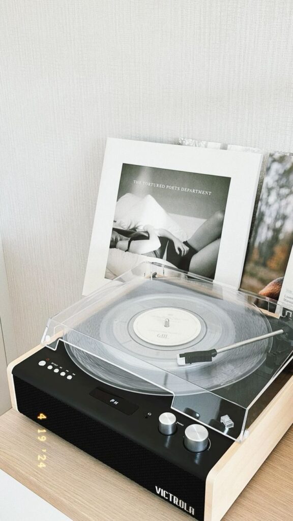the tortured poets department vinyl Vintage record player with clear vinyl and framed album art titled The Tortured Poets Department on a wooden shelf. | Sky Rye Design Vintage record player with clear vinyl and framed album art titled The Tortured Poets Department on a wooden shelf.