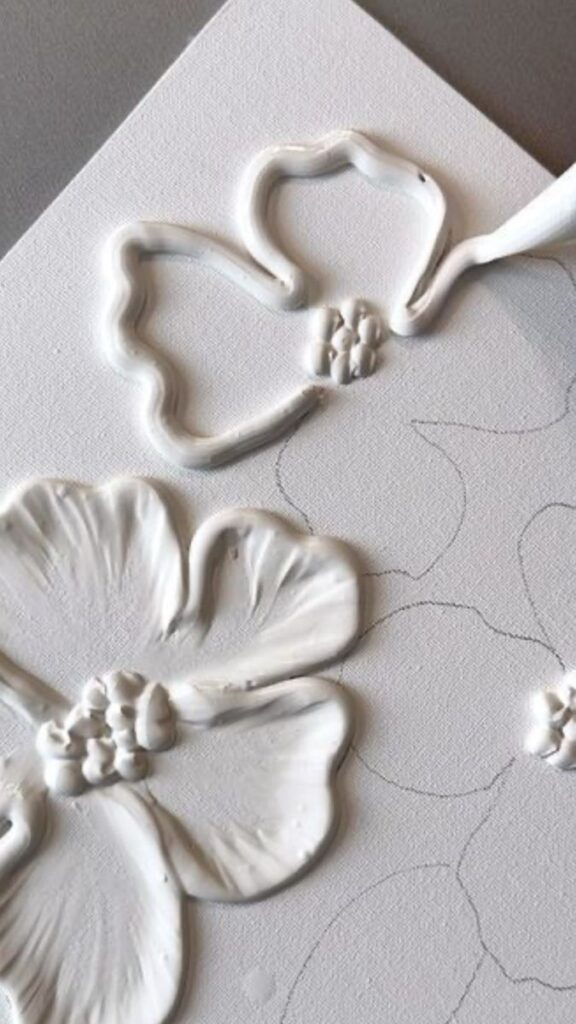 tzhbzdentjed Embossed white flowers art on canvas with intricate texture detail. | Sky Rye Design Embossed white flowers art on canvas with intricate texture detail.