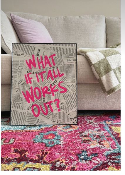 Inspirational decor with What if it all works out? text on newspaper background, beside a cozy sofa and colorful rug.