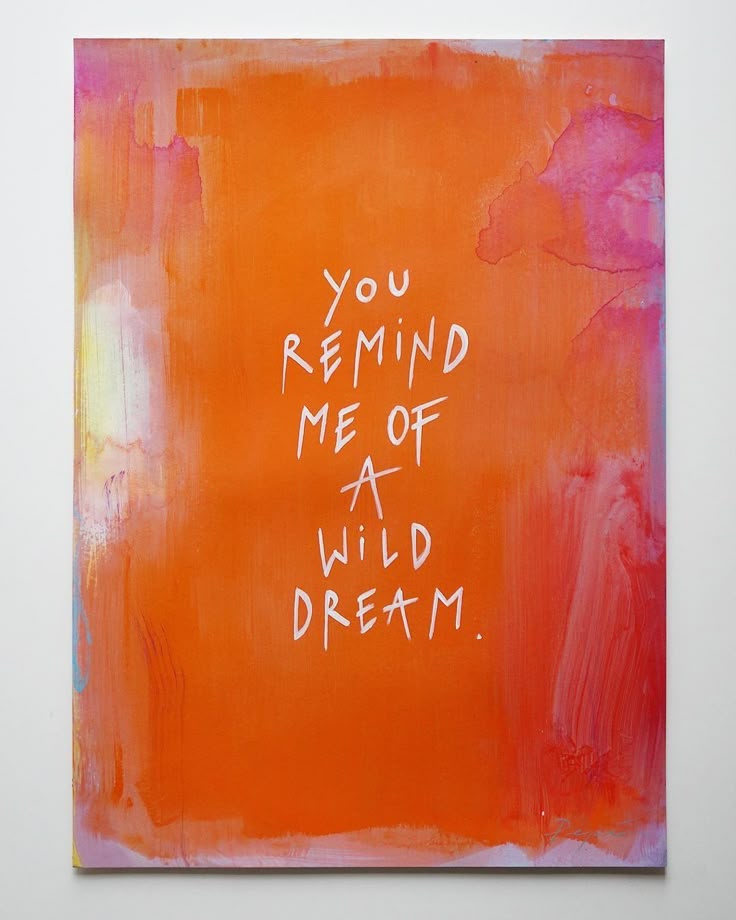 Abstract orange painting with text You remind me of a wild dream in white. Bold colors and inspirational quote.