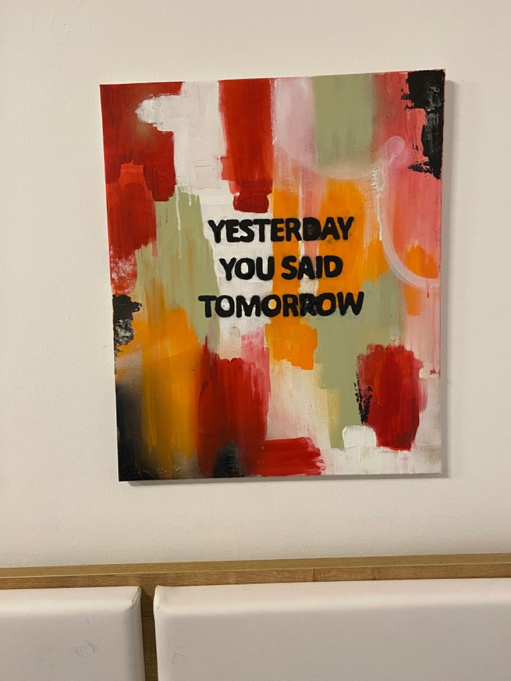 Inspirational abstract painting with text: Yesterday you said tomorrow, in bold on a colorful background.