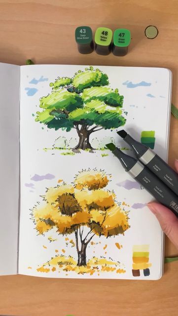 Sketchbook with vibrant tree drawings using markers, depicting seasons. Artist adds details with green and yellow marker.