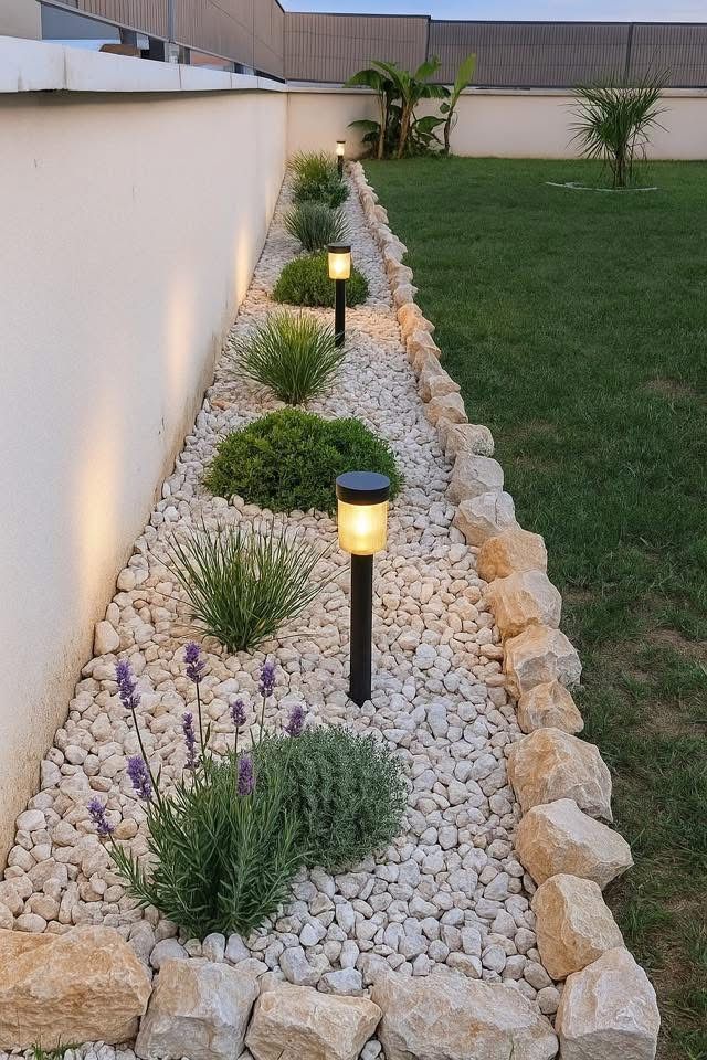 _ Modern garden with stone landscaping, decorative plants, and solar pathway lights, creating an elegant outdoor ambiance. | Sky Rye Design Modern garden with stone landscaping, decorative plants, and solar pathway lights, creating an elegant outdoor ambiance.