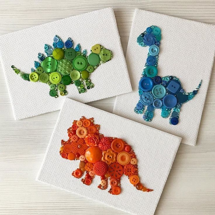_ Colorful dinosaur art made from assorted buttons on white canvases. Green stegosaurus, blue brachiosaurus, and orange triceratops. | Sky Rye Design Colorful dinosaur art made from assorted buttons on white canvases. Green stegosaurus, blue brachiosaurus, and orange triceratops.