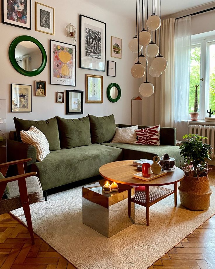 _ Stylish living room with green sofa, wall art, round wood table, and modern lighting. Cozy, contemporary decor. | Sky Rye Design Stylish living room with green sofa, wall art, round wood table, and modern lighting. Cozy, contemporary decor.