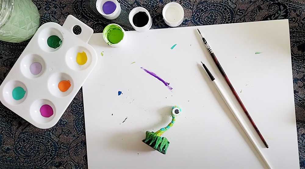 unnamed_7d5f6107-1356-4157-9d8e-f2d51a98c4a2 Art supplies on a table: paint palette, brushes, and a colorful clay creature on white paper. Creative DIY setup. | Sky Rye Design Art supplies on a table: paint palette, brushes, and a colorful clay creature on white paper. Creative DIY setup.