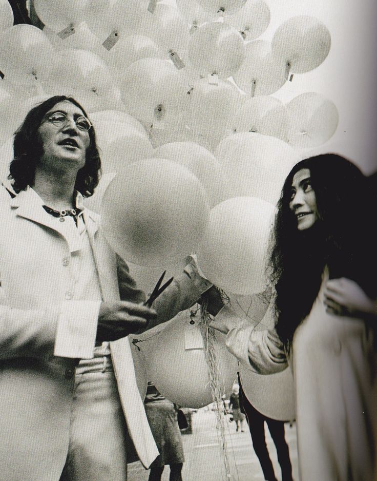 whiteout Black and white photo of two people with balloons, one holding scissors, creating a whimsical and joyful atmosphere. | Sky Rye Design Black and white photo of two people with balloons, one holding scissors, creating a whimsical and joyful atmosphere.