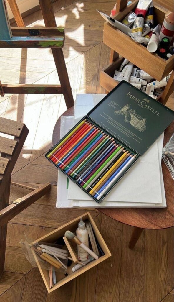zgbzdf Colorful pencils and art supplies on a wooden floor, ready for creative artwork in a sunlit studio. | Sky Rye Design Colorful pencils and art supplies on a wooden floor, ready for creative artwork in a sunlit studio.