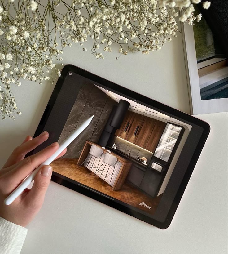 Скетч кухни Tablet displaying modern kitchen design with stylus and flowers on a white background. | Sky Rye Design Tablet displaying modern kitchen design with stylus and flowers on a white background.
