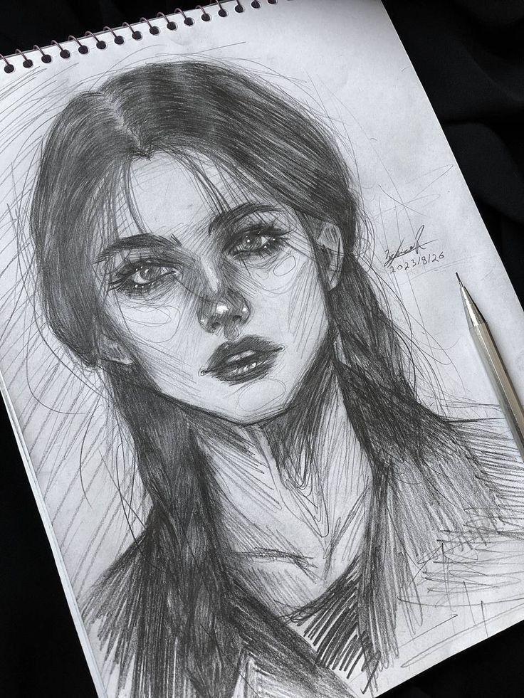 ыкеруфп Pencil sketch of a woman with long hair and intense gaze on a sketchpad, next to a mechanical pencil. | Sky Rye Design Pencil sketch of a woman with long hair and intense gaze on a sketchpad, next to a mechanical pencil.