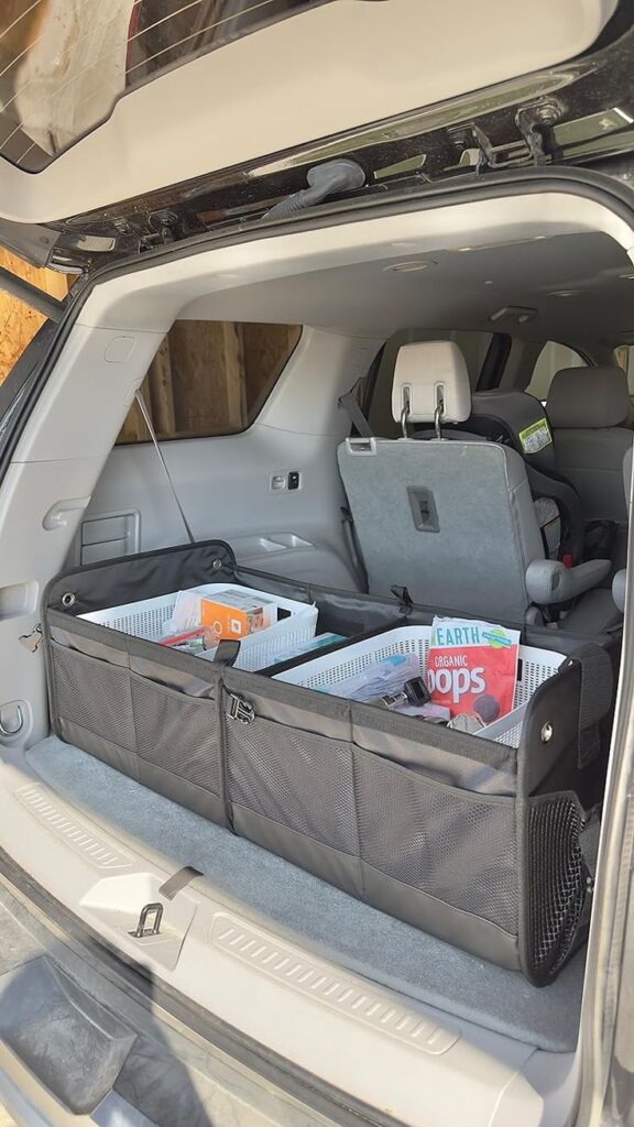 Car trunk organizer with bins and snacks for efficient vehicle storage.