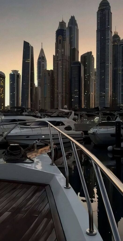 🌟 shop the look Luxury yachts docked at marina with city skyscrapers skyline at sunset. | Sky Rye Design Luxury yachts docked at marina with city skyscrapers skyline at sunset.