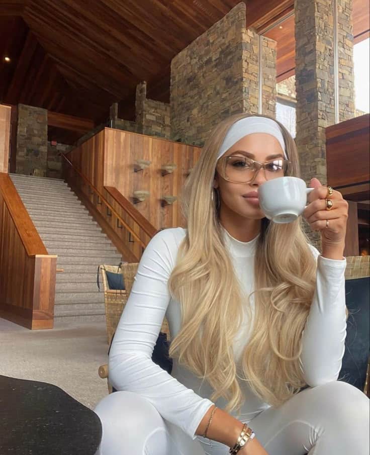 🤍 1 Elegant woman in a stylish, modern interior sipping coffee. Cozy stone and wood decor creates a warm atmosphere. | Sky Rye Design Elegant woman in a stylish, modern interior sipping coffee. Cozy stone and wood decor creates a warm atmosphere.