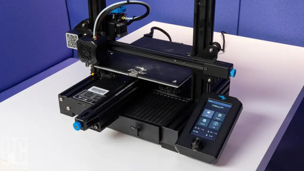 Desktop 3D printer on a table, featuring a digital control panel, ready for precision printing tasks in a tech-friendly workspace.