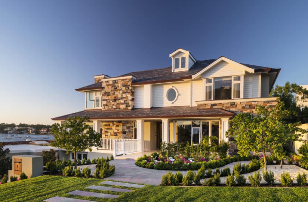 044-3-1200x790 Modern coastal home with stone facade, lush landscaping, and ocean view at sunset. Ideal luxury real estate for seaside living. | Sky Rye Design Modern coastal home with stone facade, lush landscaping, and ocean view at sunset. Ideal luxury real estate for seaside living.