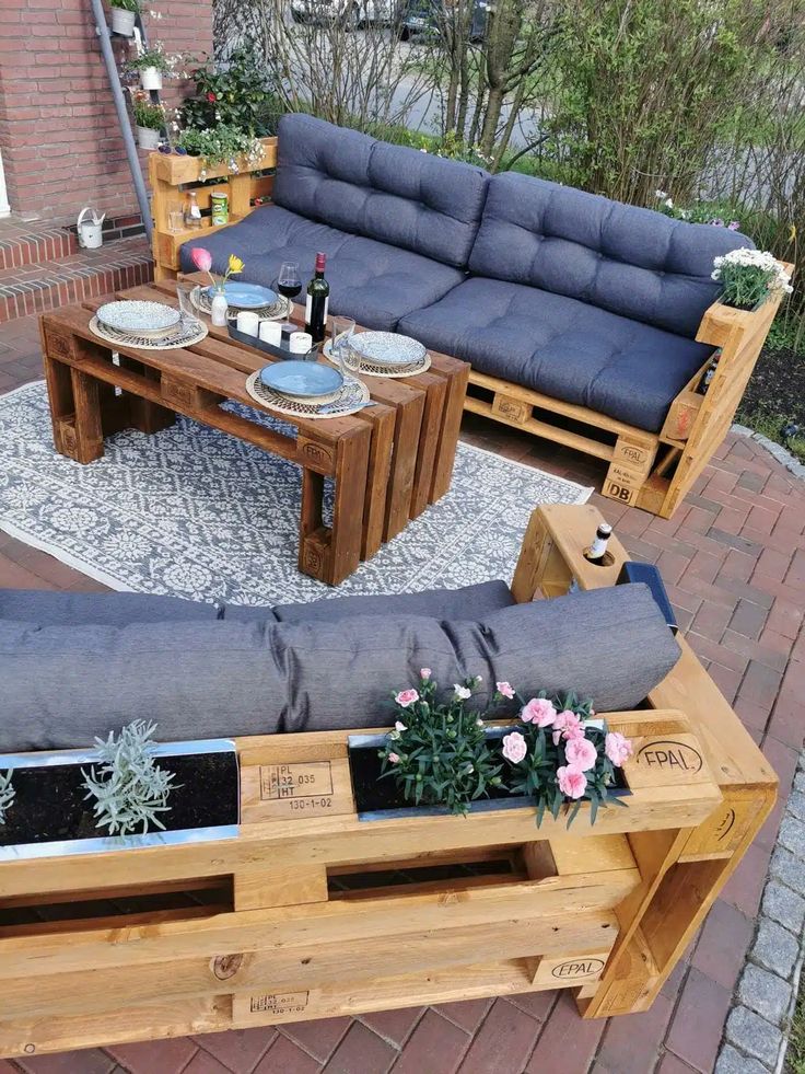 080e60b4db76e176699998f8e57a76fa Outdoor patio with DIY pallet furniture, blue cushions, and decor, featuring a cozy seating area perfect for a casual gathering. | Sky Rye Design Outdoor patio with DIY pallet furniture, blue cushions, and decor, featuring a cozy seating area perfect for a casual gathering.