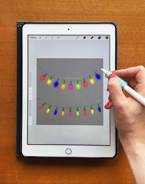 0b9b1bbc598b03e562d6af0c6d8af613 Hand drawing colorful string lights on a tablet with a digital pen app interface shown. | Sky Rye Design Hand drawing colorful string lights on a tablet with a digital pen app interface shown.