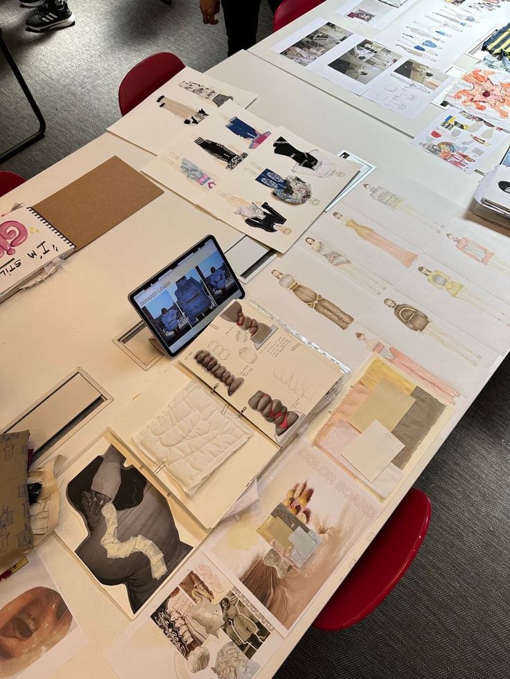 _ 1 Fashion design table with sketches, fabric samples, color boards, and a tablet, showcasing creative process in design development. | Sky Rye Design Fashion design table with sketches, fabric samples, color boards, and a tablet, showcasing creative process in design development.