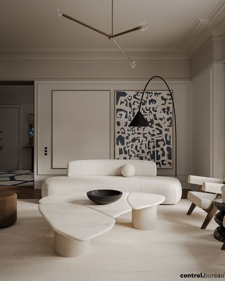 Modern living room with elegant beige sofa, abstract wall art, and unique marble coffee table. Minimalist decor and lighting.