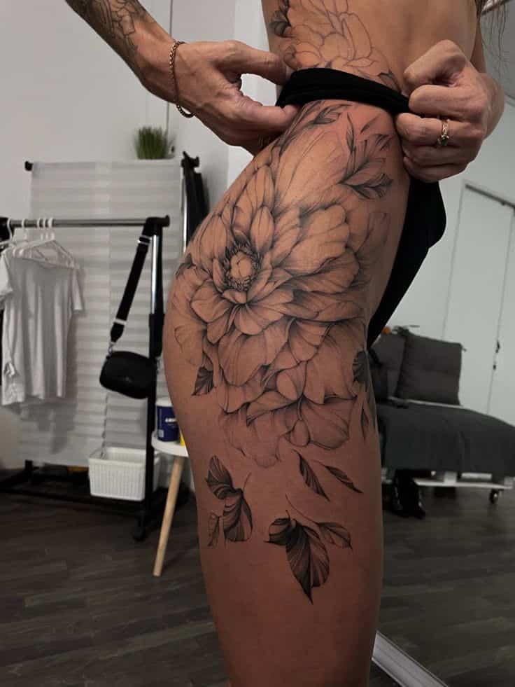 _ 1 Detailed floral thigh tattoo design, featuring a large bloom with intricate leaves, showcased in a stylish studio setting. | Sky Rye Design Detailed floral thigh tattoo design, featuring a large bloom with intricate leaves, showcased in a stylish studio setting.
