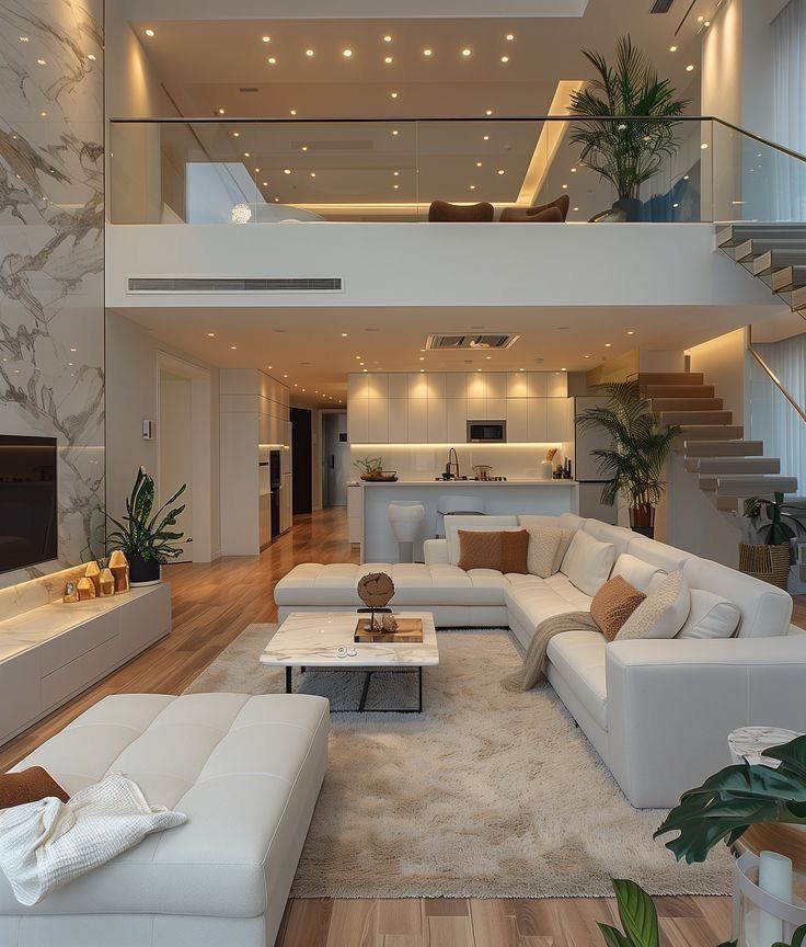 _ 1 Modern open-plan living room with white sofas, sleek kitchen, and stylish decor under warm lighting and elegant design elements. | Sky Rye Design Modern open-plan living room with white sofas, sleek kitchen, and stylish decor under warm lighting and elegant design elements.