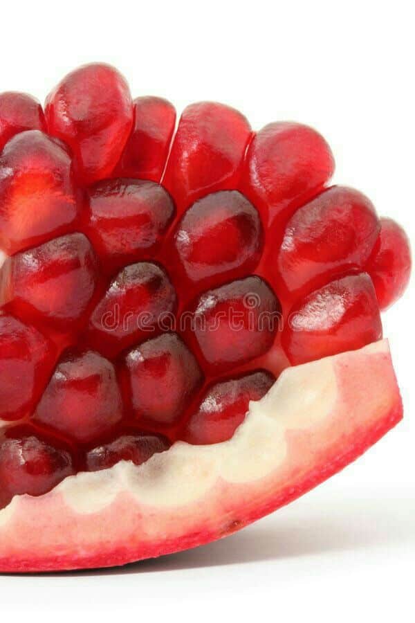 _ 1 Close-up of vibrant red pomegranate seeds, showcasing their juicy, glossy texture, against a white background. | Sky Rye Design Close-up of vibrant red pomegranate seeds, showcasing their juicy, glossy texture, against a white background.