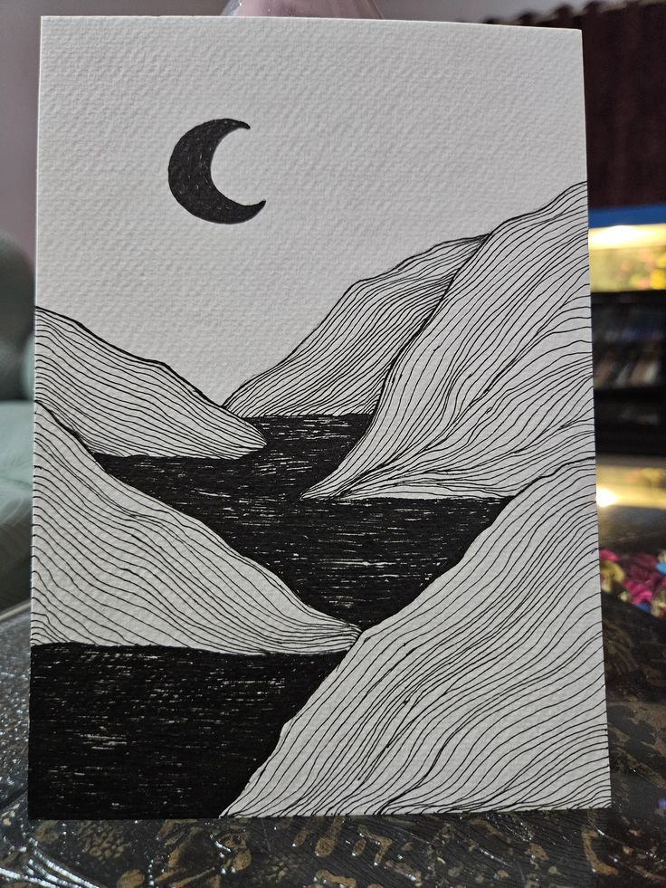 Minimalist black and white drawing of mountains and a crescent moon, featuring abstract lines and a textured background.