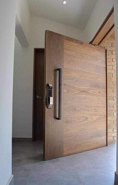 _ 10 Modern wooden pivot door with a sleek vertical handle, opening to a minimalist interior. Ideal for contemporary home entrances. | Sky Rye Design Modern wooden pivot door with a sleek vertical handle, opening to a minimalist interior. Ideal for contemporary home entrances.