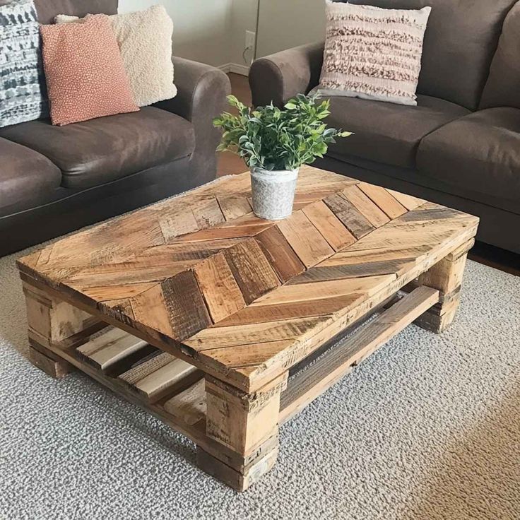 10 Creative Woodworking Projects from Recycled_ Reclaimed wood coffee table with chevron pattern and potted plant centerpiece in cozy living room with brown sofas and textured pillows. | Sky Rye Design Reclaimed wood coffee table with chevron pattern and potted plant centerpiece in cozy living room with brown sofas and textured pillows.