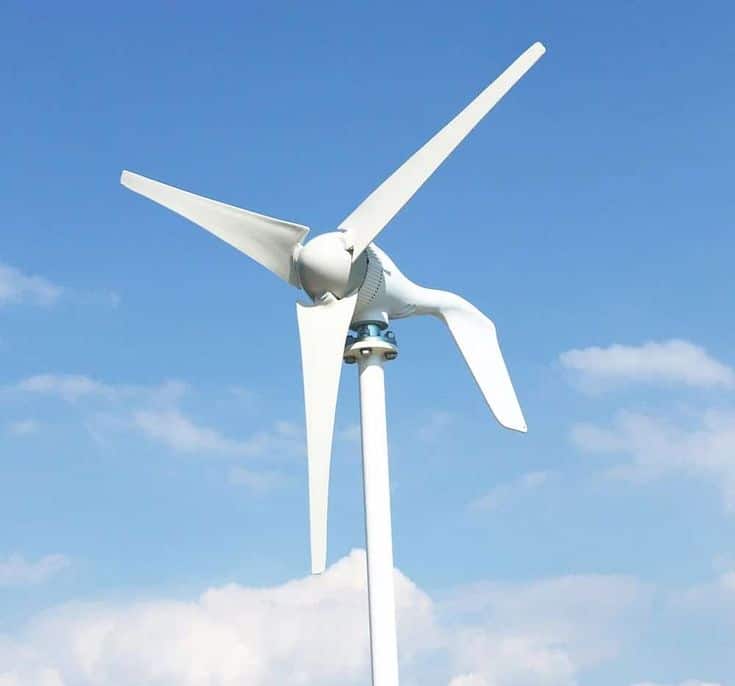 Modern wind turbine against a blue sky, harnessing renewable energy for sustainable power generation.
