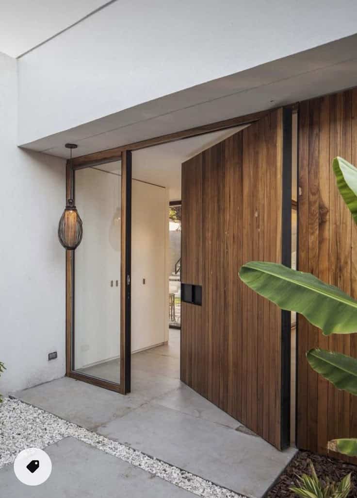 _ 11 Modern wooden front door with glass panel and potted plant, enhancing a sleek, contemporary entrance design. | Sky Rye Design Modern wooden front door with glass panel and potted plant, enhancing a sleek, contemporary entrance design.