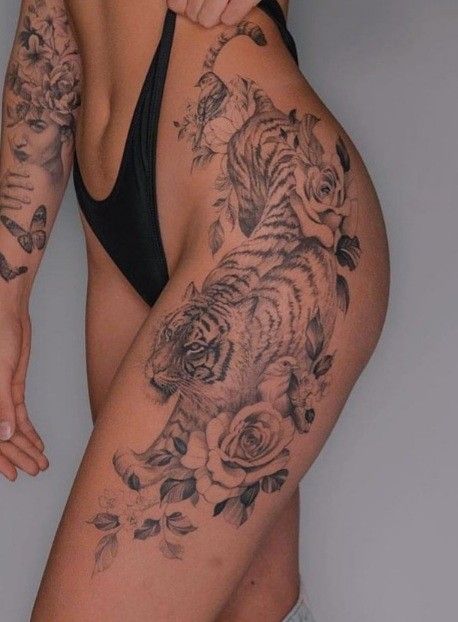 _ 11 Detailed tiger and floral tattoo on a woman's hip and thigh, showcasing bold black ink artistry and intricate floral accents. | Sky Rye Design Detailed tiger and floral tattoo on a woman's hip and thigh, showcasing bold black ink artistry and intricate floral accents.