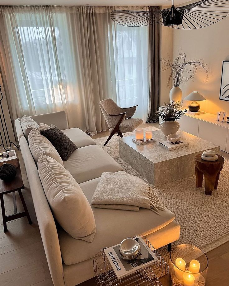 11d45dc0-7db8-4e62-a884-0b6bced250b3 Modern living room with a cozy beige sectional sofa, marble coffee table, elegant decor, soft lighting, and neutral color palette. | Sky Rye Design Modern living room with a cozy beige sectional sofa, marble coffee table, elegant decor, soft lighting, and neutral color palette.