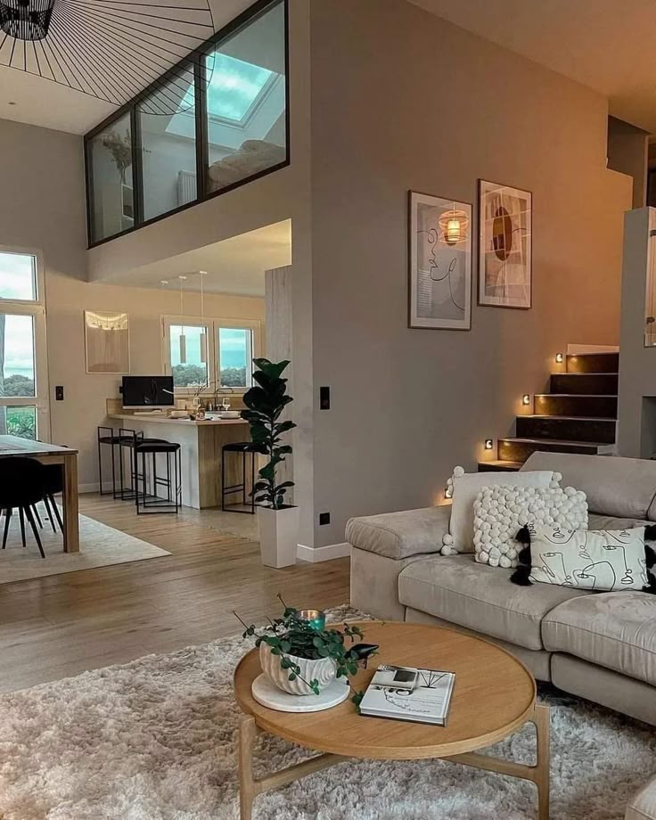 _ 13 Modern open-plan living room with plush sofa, stylish decor, round coffee table, and kitchen view. Cozy interior design with natural light. | Sky Rye Design Modern open-plan living room with plush sofa, stylish decor, round coffee table, and kitchen view. Cozy interior design with natural light.