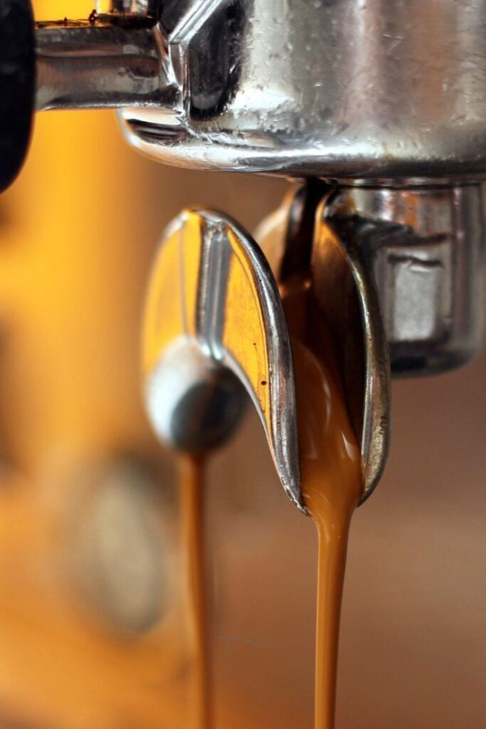 _ 13 Close-up of espresso flowing from a machine, capturing creamy coffee extraction for a perfect shot. | Sky Rye Design Close-up of espresso flowing from a machine, capturing creamy coffee extraction for a perfect shot.