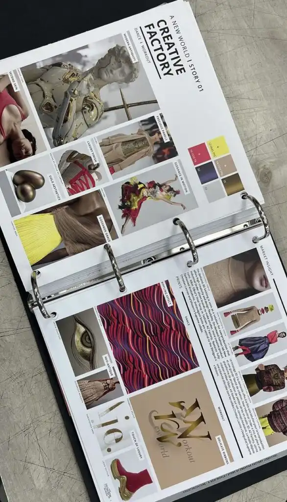 _ 13 Open binder with a fashion mood board titled Creative Factory, showcasing various design inspirations and color palettes. | Sky Rye Design Open binder with a fashion mood board titled Creative Factory, showcasing various design inspirations and color palettes.