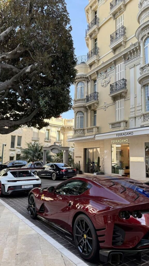 13f26efa-c15c-4ae5-87e5-37ca2821cbc0 Luxury sports car parked in front of elegant building with Ferragamo store, tree-lined street in upscale neighborhood. | Sky Rye Design Luxury sports car parked in front of elegant building with Ferragamo store, tree-lined street in upscale neighborhood.