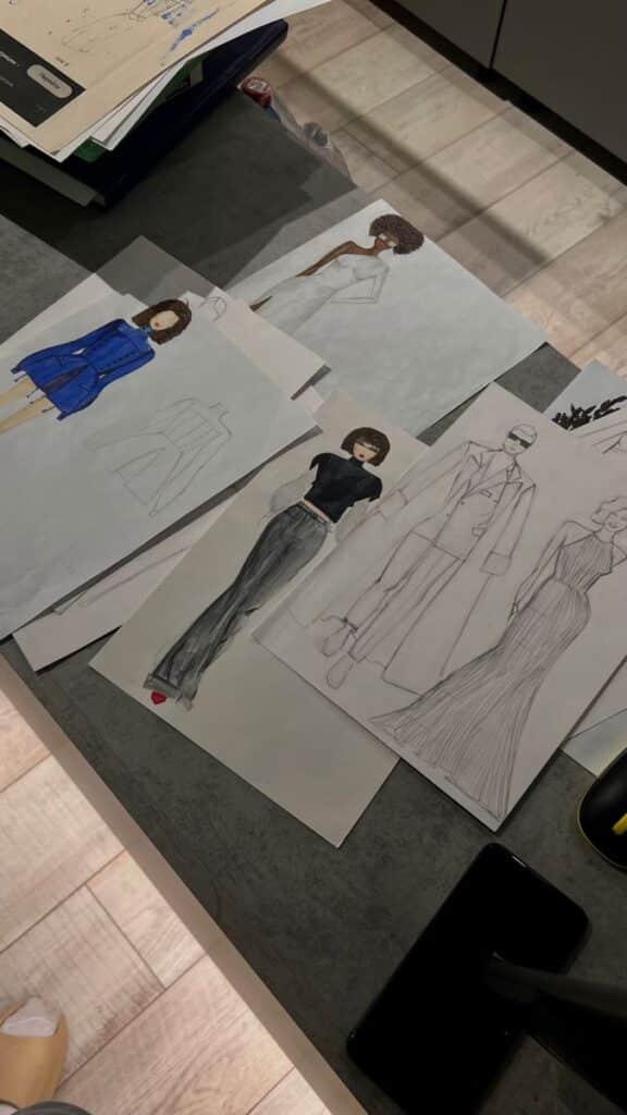 _ 17 Fashion design sketches on a table, featuring various outfits in different styles and colors, ready for fashion development. | Sky Rye Design Fashion design sketches on a table, featuring various outfits in different styles and colors, ready for fashion development.