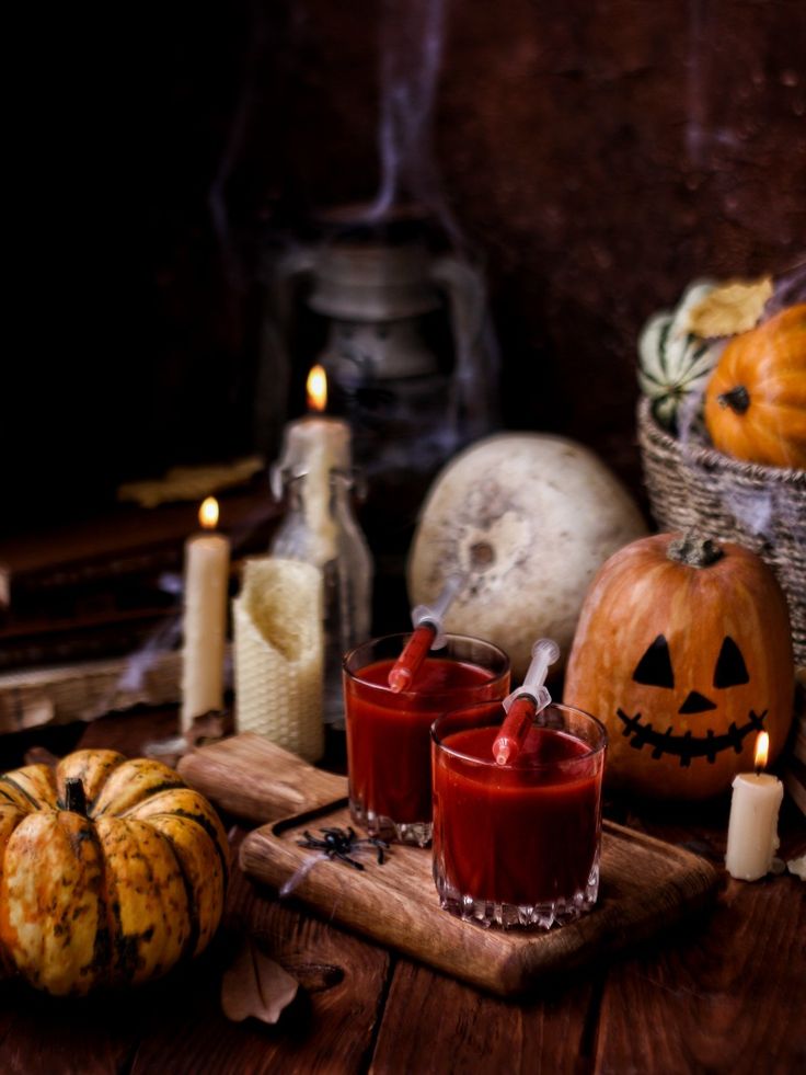 _ 17 Halloween-themed setup with carved pumpkins, candles, and spooky red drinks in glasses on a wooden board, perfect for a festive celebration. | Sky Rye Design Halloween-themed setup with carved pumpkins, candles, and spooky red drinks in glasses on a wooden board, perfect for a festive celebration.