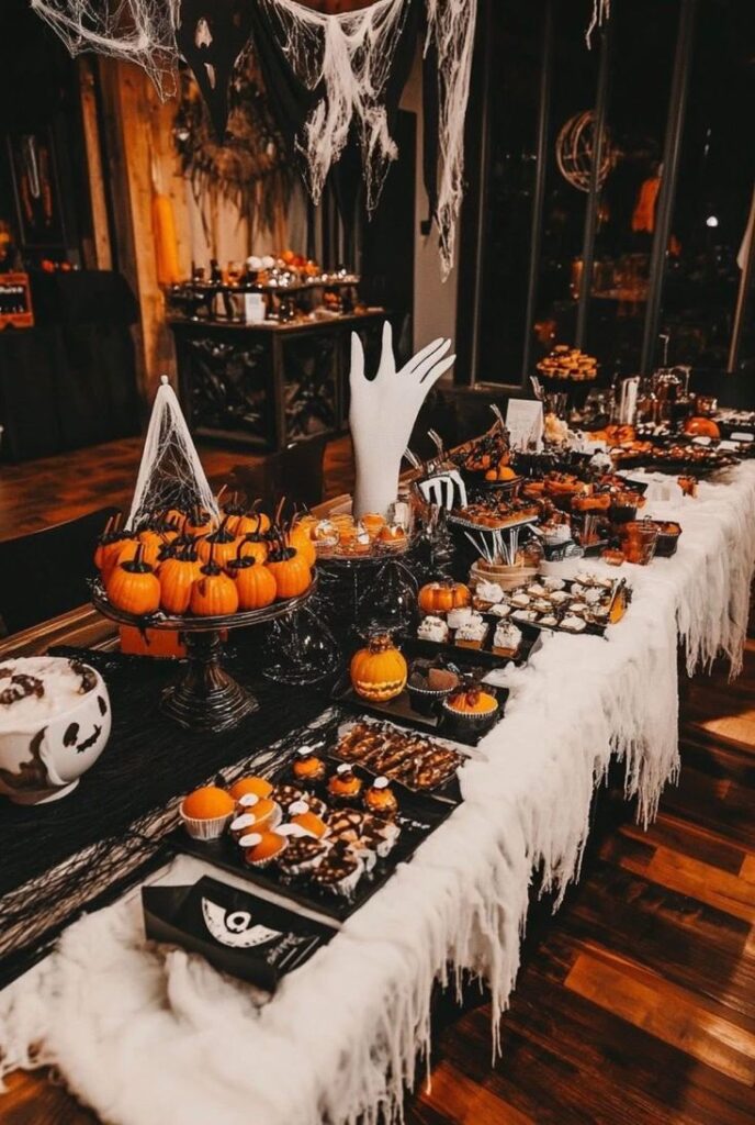 _ 18 Festive Halloween dessert table with pumpkins, cobwebs, and spooky treats. Creepy atmosphere perfect for a Halloween party. | Sky Rye Design Festive Halloween dessert table with pumpkins, cobwebs, and spooky treats. Creepy atmosphere perfect for a Halloween party.