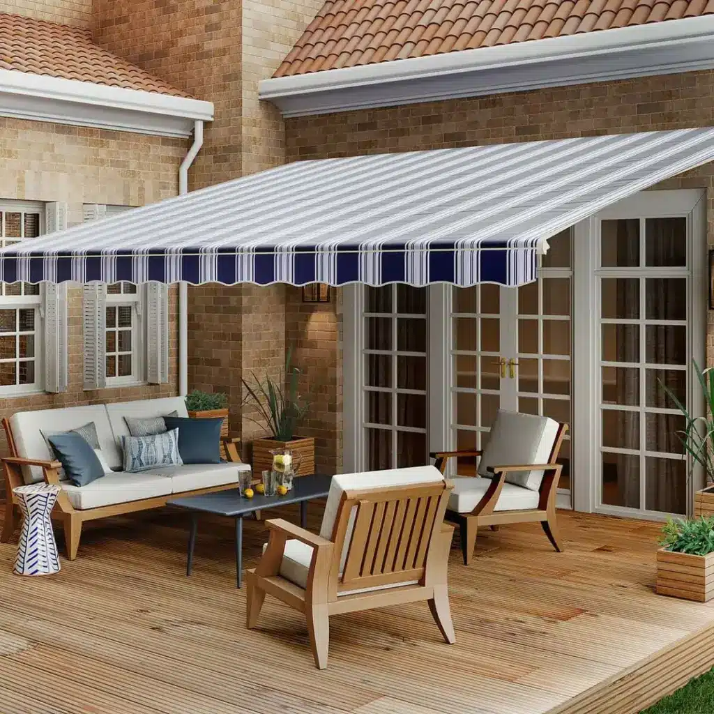 19-11058-SunSetter-XL-Awning-01 Patio with striped awning, cozy seating, and a wooden deck, perfect for relaxing or entertaining in a stylish outdoor space. | Sky Rye Design Patio with striped awning, cozy seating, and a wooden deck, perfect for relaxing or entertaining in a stylish outdoor space.