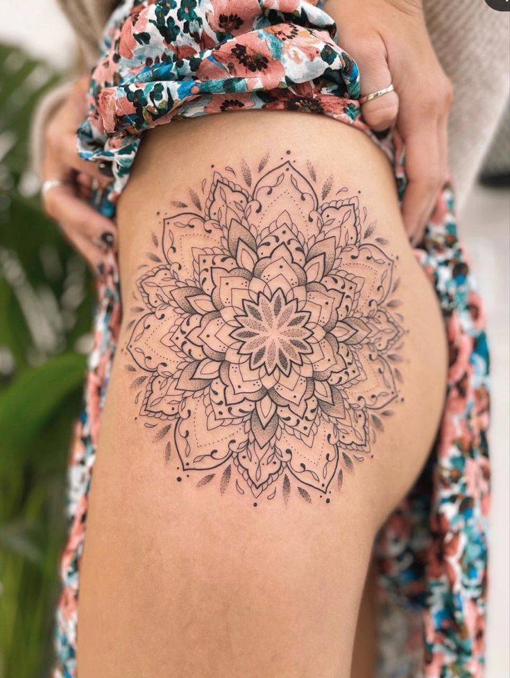_ 2 Intricate mandala tattoo on a thigh, showcasing detailed geometric patterns and floral elements, complemented by colorful fabric. | Sky Rye Design Intricate mandala tattoo on a thigh, showcasing detailed geometric patterns and floral elements, complemented by colorful fabric.
