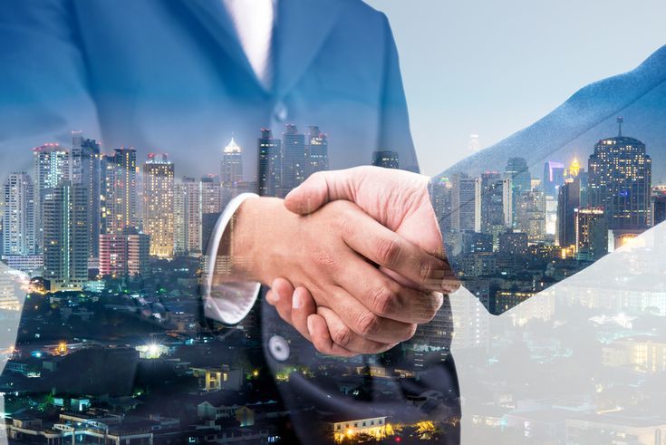 _ 2 Business handshake with cityscape background, symbolizing urban partnerships, corporate collaboration, and successful business deals. | Sky Rye Design Business handshake with cityscape background, symbolizing urban partnerships, corporate collaboration, and successful business deals.