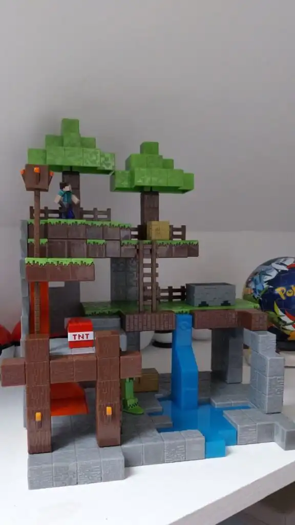 _ 2 Toy Minecraft landscape with pixelated trees, figure, TNT block, and water feature, capturing the game's iconic blocky style. | Sky Rye Design Toy Minecraft landscape with pixelated trees, figure, TNT block, and water feature, capturing the game's iconic blocky style.
