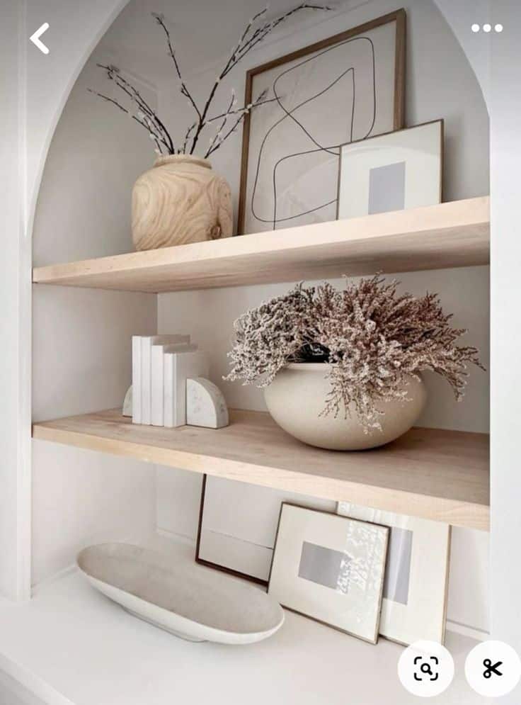 _ - 2025-12-01T203325635 Minimalist wooden shelves with abstract art, a wooden vase, and a ceramic pot with white floral arrangement for modern home decor. | Sky Rye Design Minimalist wooden shelves with abstract art, a wooden vase, and a ceramic pot with white floral arrangement for modern home decor.