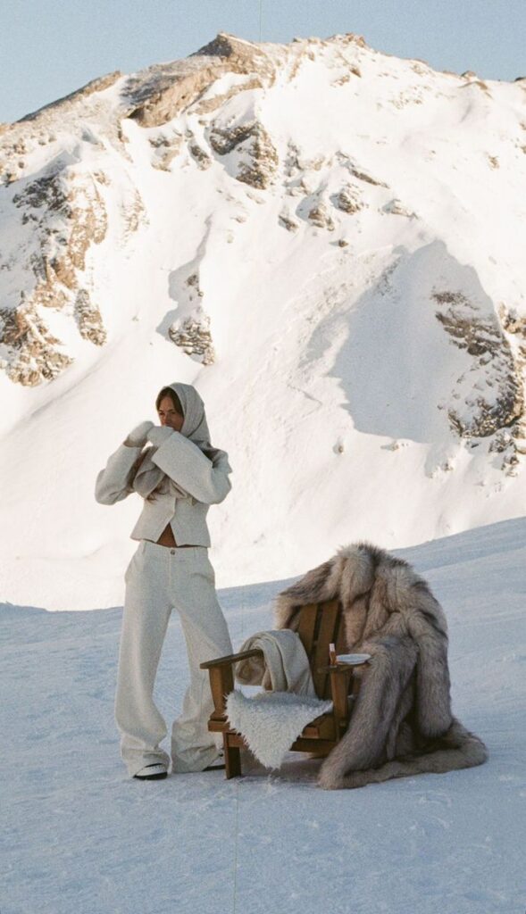 _ - 2025-12-04T130135718 Person in winter attire enjoys snowy mountain view beside fur-clad chair on a sunny day, blending relaxation with stunning alpine scenery. | Sky Rye Design Person in winter attire enjoys snowy mountain view beside fur-clad chair on a sunny day, blending relaxation with stunning alpine scenery.